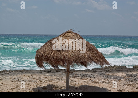 Straw sun umbrella on the beach, Cozumel Mexico Central America Stock Photo