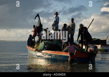 Men setting off to Mozambique Island to work and fish using a fishing boat as an overloaded ferry on the Indian Ocean Stock Photo