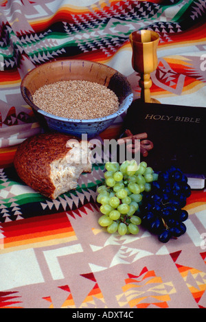 Wheat bread grapes cross chalice and bible on Navajo blanket. St Paul Minnesota USA Stock Photo