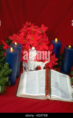 Bible advent candles poinsettias and Lliadro porcelain figurine of Mary holding Jesus on the donkey. St Paul Minnesota USA Stock Photo
