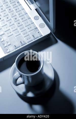 Computer Comm duotone grey greyish laptop notebook plastic coffee cup porcelain silicon microchips keyboard modern apple macinto Stock Photo