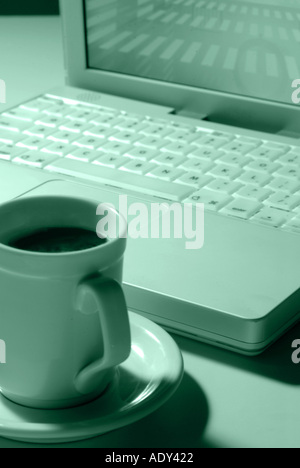 Computer Comm duotone grey greyish laptop notebook plastic coffee cup porcelain silicon microchips keyboard modern apple macinto Stock Photo