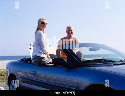 Couple in Covertible Car with Surf Boards Stock Photo