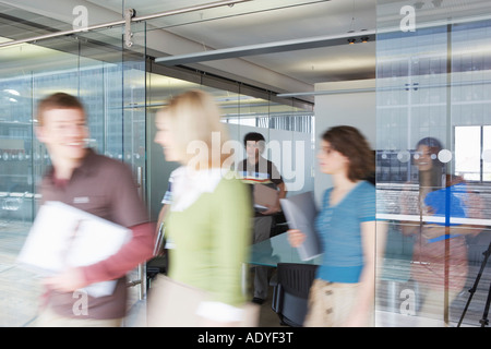 Office workers leaving conference room, long exposure Stock Photo