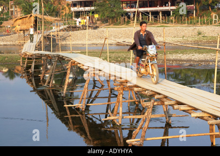 Motorcyclist Crossing Bamboo Footbridge Stock Photo