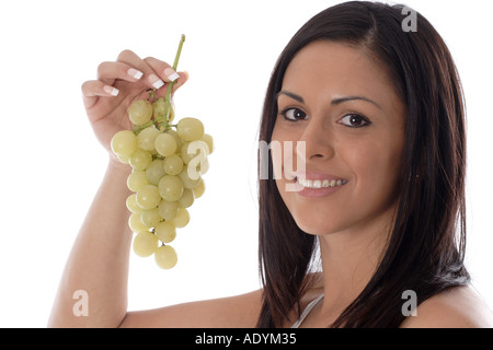 black-haired young woman holding grapes. Stock Photo