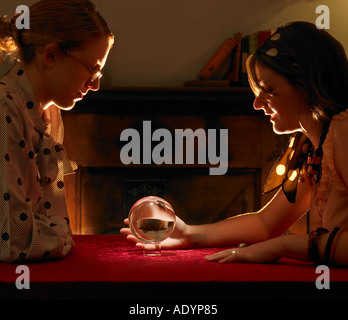 Fortune teller and client looking into crystal ball close up Stock Photo