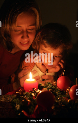 mother with child in front of an Advent wreath Stock Photo