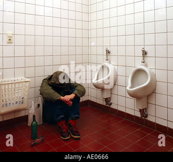 drug addict in a public toilet Stock Photo