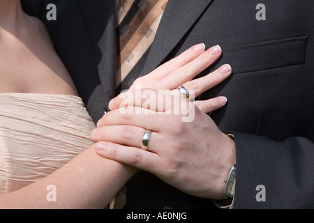 Weddings rings and holding hands Stock Photo