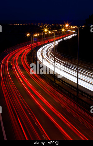 Streaks of car lights on motorway at night. Nice smooth curve. Stock Photo