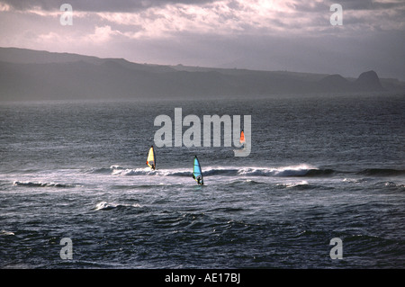 three windsurfers race in Maui at the famous site at Ho'okipa Stock Photo