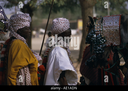 NIGERIA West Africa Katsina Salah Day The Emirs entourage in traditional dress including horse wearing heavily decorated bridle Stock Photo