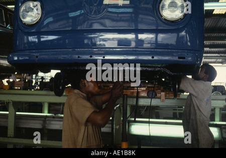 NIGERIA West Africa Lagos Men working on underside of car on VW Volkswagen car assembly line Stock Photo