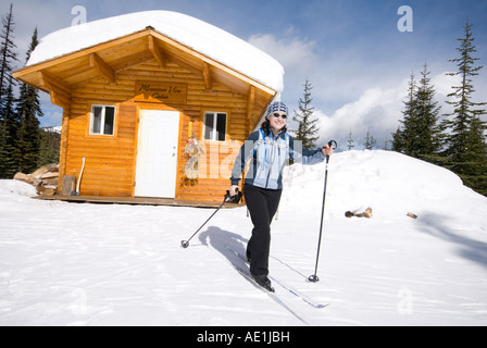 A Woman Cross Country Skiing Past A Warming Hut At Silver Star