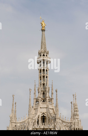 Spire of Duomo di Milano, the Milan Cathedral, from the roof, with the golden Madonna statue, La Madunina Stock Photo