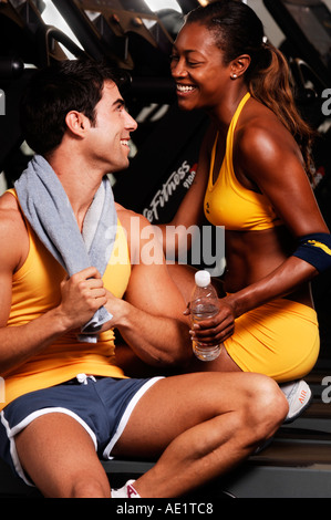 young fit couple relaxing after workout at the gym Stock Photo