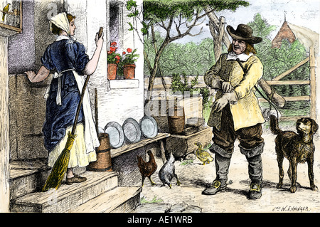 New England colonial couple in a dooryard 1600s. Hand-colored woodcut Stock Photo