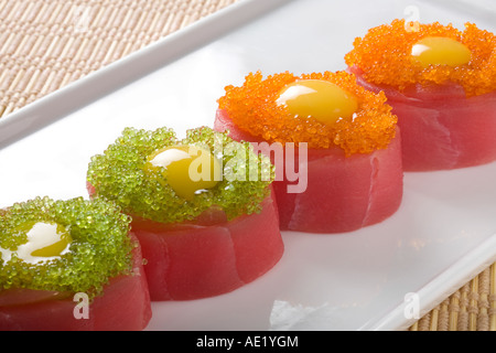 A Japanese dish on a plate consisting of 4 pieces of sushi. Stock Photo