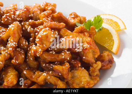 Orange Sesame chicken peel chinese food with seeds seed dish white plate delicious mouth watering savory savor eat cutout enjoy Stock Photo