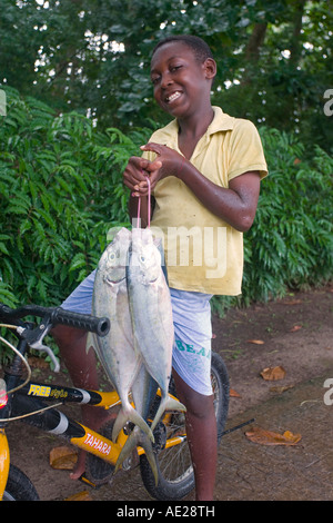 Young boy carrying fresh fish back home La Digue Island Seychelles Stock Photo