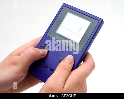 Hands Holding Small Handheld Game Pokemon on Gameboy Colour Stock