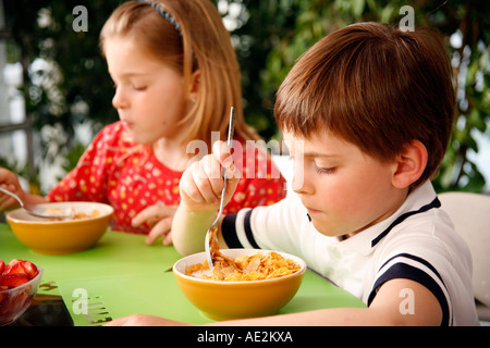 Children eating breakfast Stock Photo