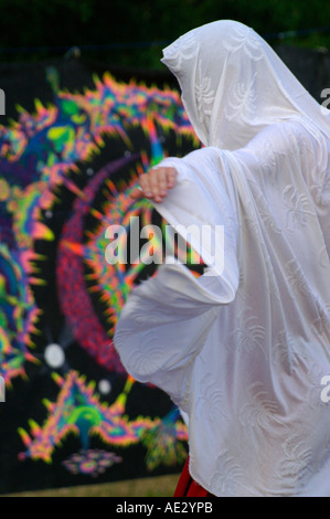 Hilltop 2006 - slender boy with white veil dancing at rave party in front of  psychedelic mandala Stock Photo