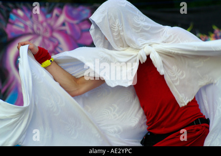 Hilltop 2006 - slender boy with white veil dancing at rave party in front of  psychedelic mandala Stock Photo