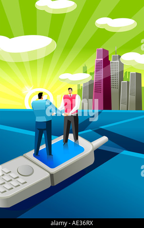 Two businessmen standing on a mobile phone and holding hands Stock Photo