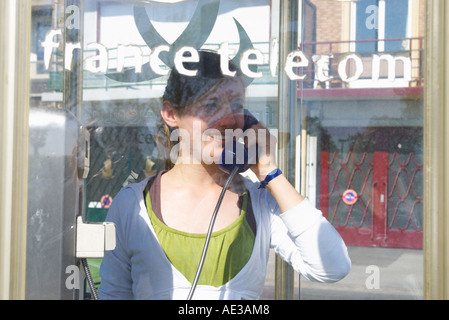 teenage girl in a France Telecom public telephone booth Stock Photo