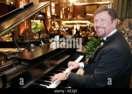 Cincinnati Ohio,Hilton Netherland Plaza,hotel,Orchids at Palm Court,restaurant restaurants food dining cafe cafes,man men male,pianist,piano player,mu Stock Photo