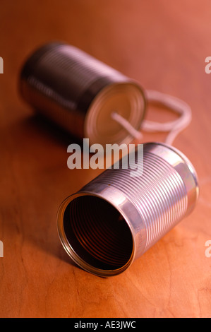 Tin can telephone on wooden table Stock Photo