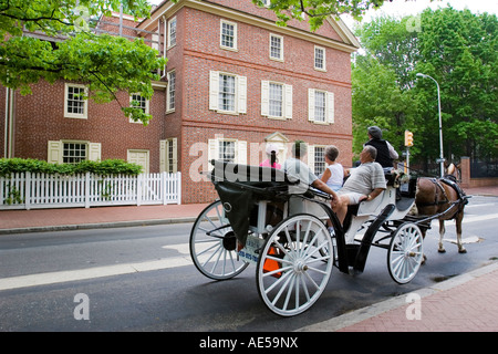 Tourists in a horse drawn cart in front of Todd House on a guided tour of historic buildings in Philadelphia Pennsylvania Stock Photo