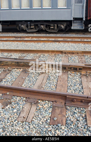 Rows of train tracks with steps to gray Southern Pacific railroad car parked at the Old Town Sacramento station Stock Photo