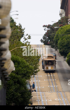 Cable car filled with tourists on vacation making its way up a steep section of Powell Street in San Francisco California Stock Photo