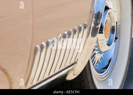 Vintage Cadillac car wheel with chrome side design at a classic auto show Stock Photo