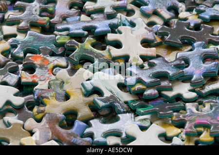Closeup of the pieces of a jigsaw puzzle in a pile conveys idea of confusion or trying to figure out a problem Stock Photo