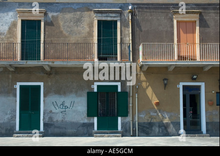 Shuttered doors and windows on historic building in Acitrezza Sicily Stock Photo