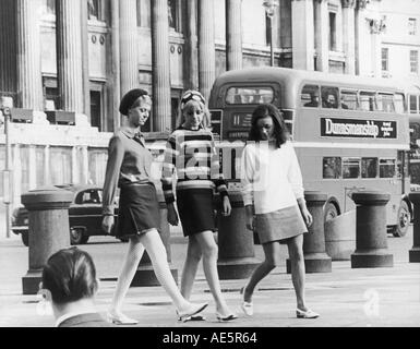 Three young women wearing mini skirts on a freezing cold December night ...