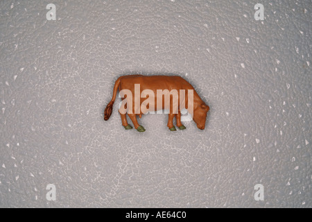 Plastic model cow on white plastic background Stock Photo