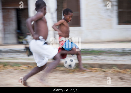 Boys play football among the crumbling colonial mansions on Ilha do Mozambique Stock Photo