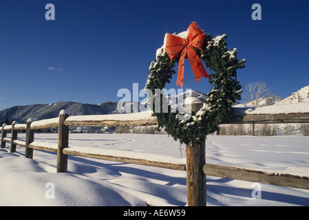 Idaho Sun Valley Christmas wreath on wood fence view toward snow covered Baldy Mountain Stock Photo