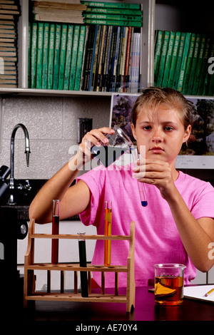 Student girl age 13 in Eighth grade learning science learning at lab desk Stock Photo
