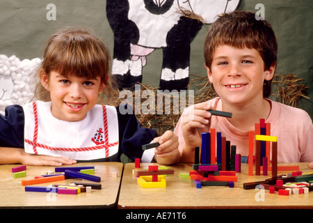 Students in first grade working together on block assignment in school Stock Photo