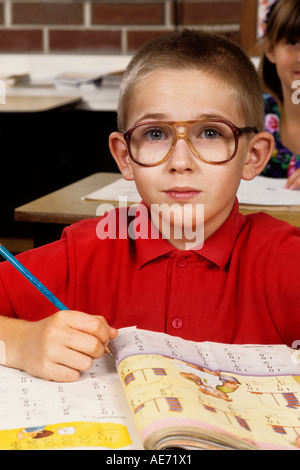 Student age 7 working in book on assignment in school portrait Stock Photo