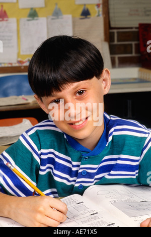 Student age 8 working in book on assignment in school portrait Stock Photo