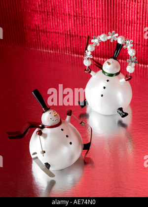 Two Christmas snowmen on a red festive background Stock Photo