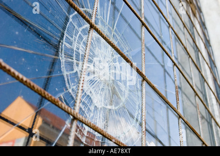 broken window with security steel bars Stock Photo