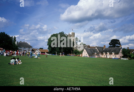 Summer Fete on the village green 5 Bells pub Pink Thatched cottage Church of St Mary Stock Photo